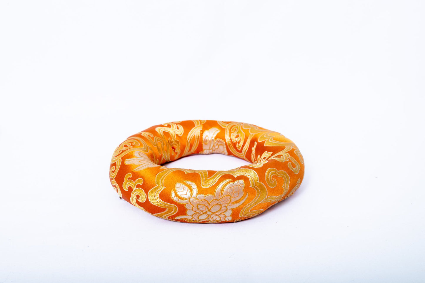 Ring singing bowl cushion in orange